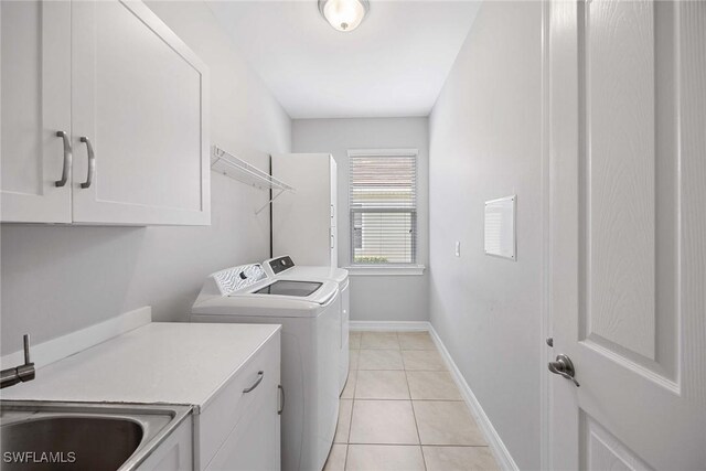 14601 Tropical Dr, Naples, FL 34114 - laundry area featuring cabinet space, separate washer and dryer, and light tile patterned flooring