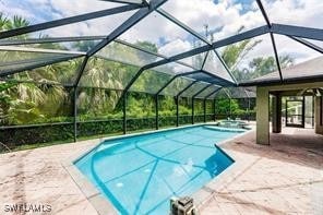 4238 Golfair Ln, North Port, FL 34288 - view of swimming pool with a patio area, a pool with connected hot tub, and glass enclosure
