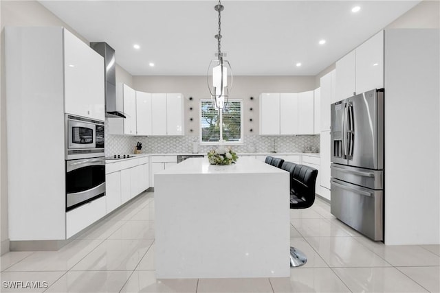 1806 41st St SW, Naples, FL 34116 - kitchen featuring appliances with stainless steel finishes, wall chimney exhaust hood, backsplash, white cabinetry, and light countertops