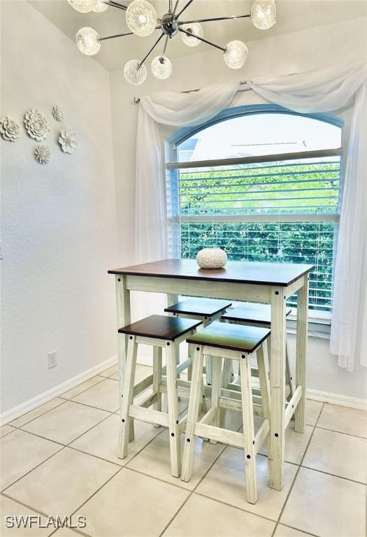 1958 Terrazzo Ln, Naples, FL 34104 - dining room with a chandelier and tile patterned floors