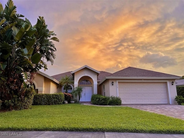 1958 Terrazzo Ln, Naples, FL 34104 - ranch-style home featuring stucco siding, a yard, an attached garage, and driveway