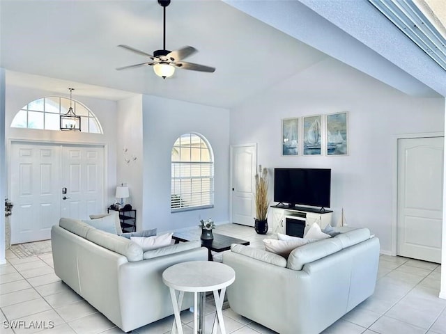 1958 Terrazzo Ln, Naples, FL 34104 - living room featuring vaulted ceiling, ceiling fan, and light tile patterned floors