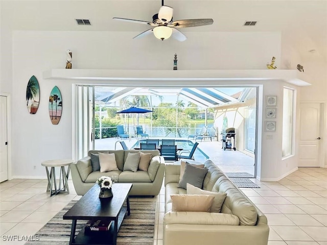 1958 Terrazzo Ln, Naples, FL 34104 - living area featuring light tile patterned floors, a sunroom, and ceiling fan