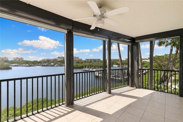 420 Cove Tower Dr Unit 304, Naples, FL 34110 - unfurnished sunroom with tile patterned flooring and a water view