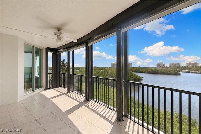 420 Cove Tower Dr Unit 304, Naples, FL 34110 - unfurnished sunroom featuring a water view and tile patterned flooring