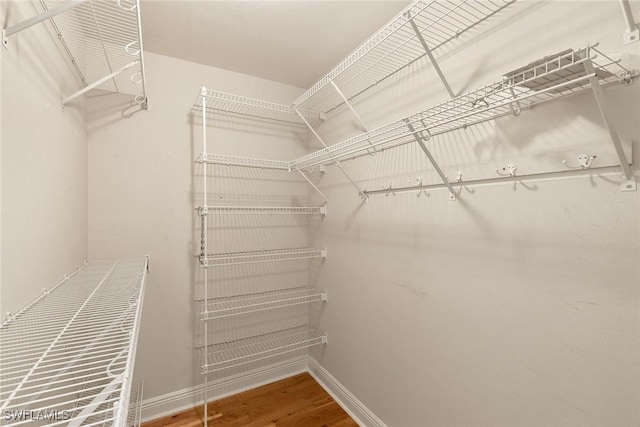420 Cove Tower Dr Unit 304, Naples, FL 34110 - spacious closet featuring wood finished floors