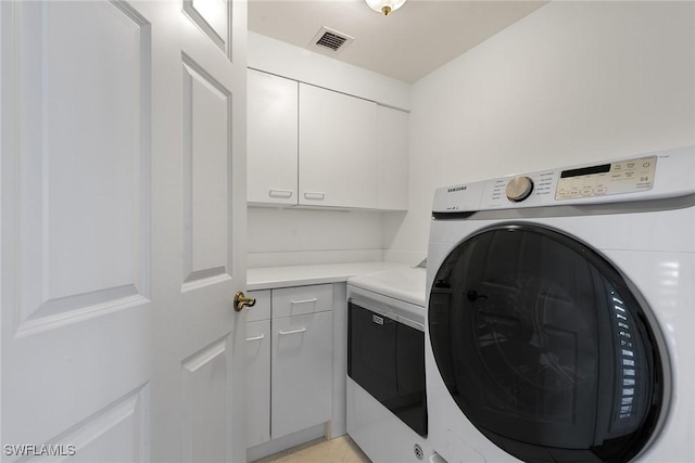 420 Cove Tower Dr Unit 304, Naples, FL 34110 - washroom featuring washer / dryer and cabinet space