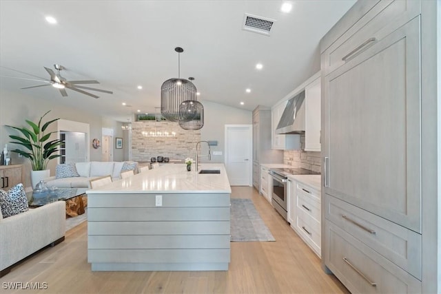 9245 Independence Way, Fort Myers, FL 33913 - kitchen featuring stainless steel stove, wall chimney range hood, open floor plan, tasteful backsplash, and a ceiling fan