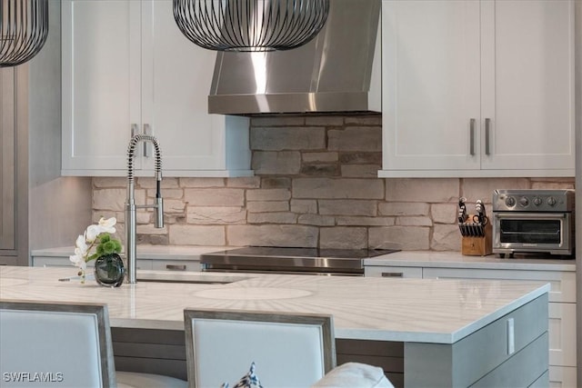 9245 Independence Way, Fort Myers, FL 33913 - kitchen with wall chimney exhaust hood, backsplash, and white cabinets