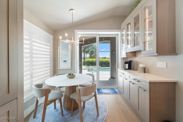 9245 Independence Way, Fort Myers, FL 33913 - dining area with lofted ceiling, light wood-style flooring, and a chandelier