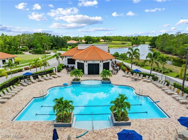 7625 Arbor Lakes Ct Unit 315, Naples, FL 34112 - community pool featuring a water view, a patio, and view of wooded area
