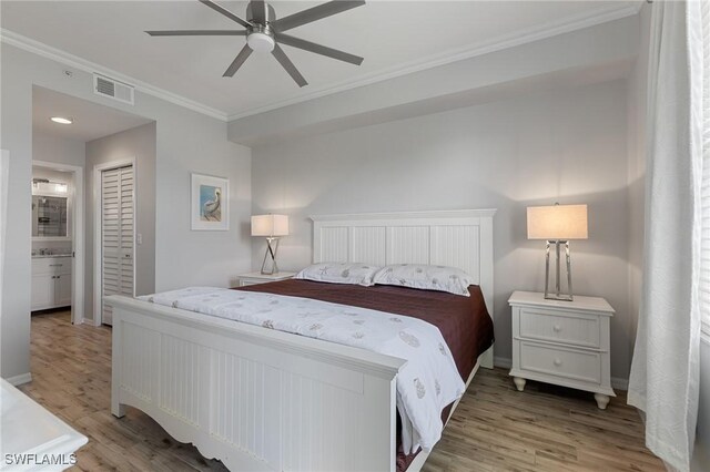 7625 Arbor Lakes Ct Unit 315, Naples, FL 34112 - bedroom with ornamental molding, light wood-style floors, a closet, and ceiling fan