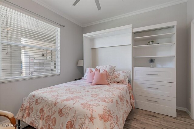 7625 Arbor Lakes Ct Unit 315, Naples, FL 34112 - bedroom with wood finished floors, ornamental molding, multiple windows, and ceiling fan