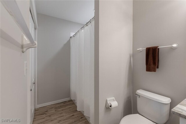 7625 Arbor Lakes Ct Unit 315, Naples, FL 34112 - bathroom featuring wood finished floors and curtained shower