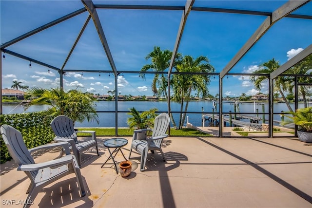 2022 Four Mile Cove Pkwy, Cape Coral, FL 33990 - view of patio / terrace featuring a lanai, a water view, a boat dock, and boat lift