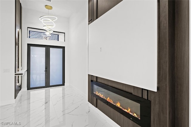 2302 SW 16th Ter, Cape Coral, FL 33991 - foyer entrance featuring a glass covered fireplace and light marble finish floors