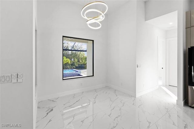 2302 SW 16th Ter, Cape Coral, FL 33991 - unfurnished room featuring marble look tiles and a chandelier