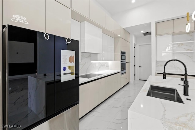 2302 SW 16th Ter, Cape Coral, FL 33991 - kitchen featuring modern cabinets, light marble finish flooring, white cabinetry, hanging light fixtures, and light stone counters