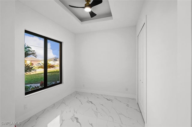 2302 SW 16th Ter, Cape Coral, FL 33991 - unfurnished room with marble finish flooring, ceiling fan, and a raised ceiling