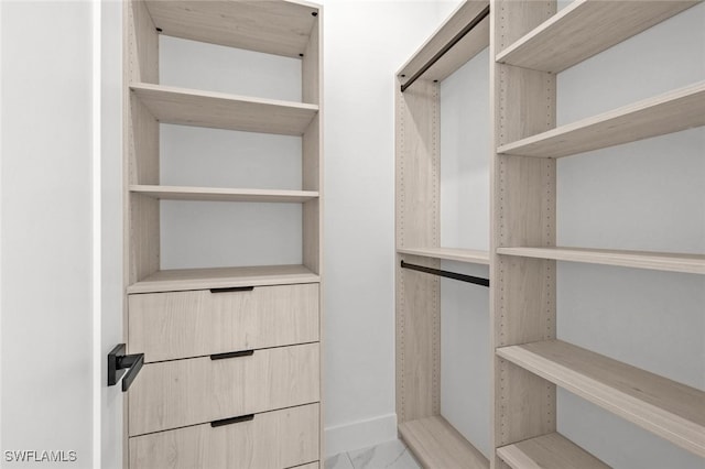 2302 SW 16th Ter, Cape Coral, FL 33991 - walk in closet featuring light marble finish flooring