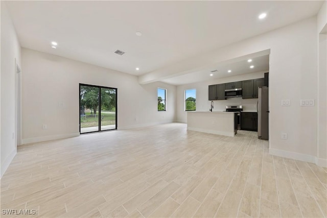 2701 53rd St W, Lehigh Acres, FL 33971 - unfurnished living room with recessed lighting and light wood-style floors