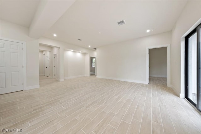 2701 53rd St W, Lehigh Acres, FL 33971 - unfurnished living room with healthy amount of natural light, recessed lighting, and light wood-style floors
