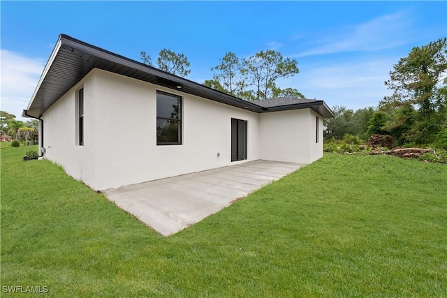 2701 53rd St W, Lehigh Acres, FL 33971 - rear view of house with stucco siding, a yard, and a patio