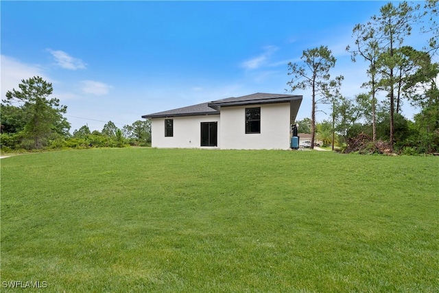 2701 53rd St W, Lehigh Acres, FL 33971 - back of house with a lawn and stucco siding