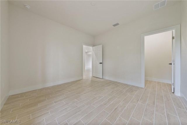 2703 54th St W, Lehigh Acres, FL 33971 - unfurnished room featuring light wood-style flooring and a smoke detector