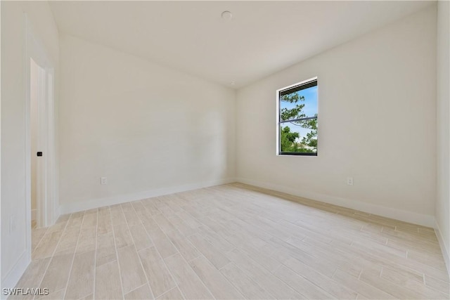 2703 54th St W, Lehigh Acres, FL 33971 - spare room with light wood-style floors and baseboards