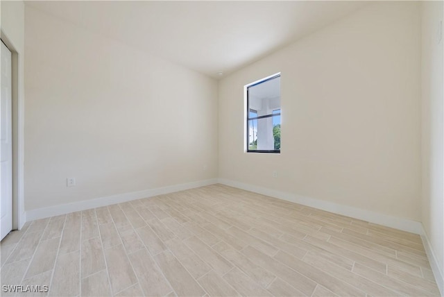 2703 54th St W, Lehigh Acres, FL 33971 - empty room featuring light wood-style floors and baseboards