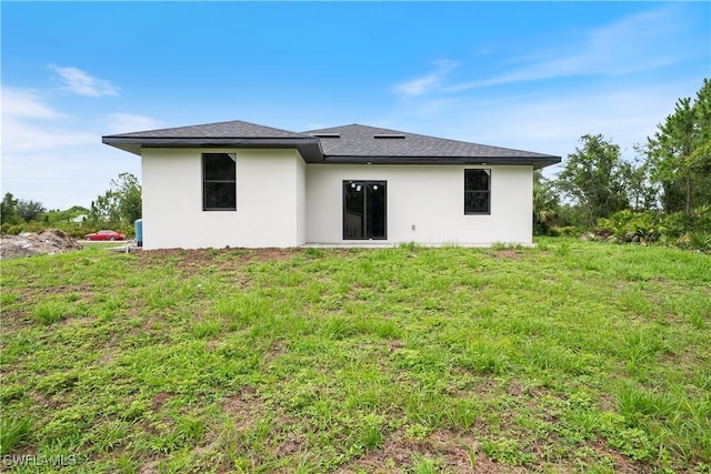 2703 54th St W, Lehigh Acres, FL 33971 - rear view of property featuring stucco siding and a shingled roof