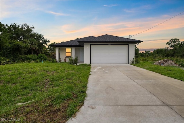 2703 54th St W, Lehigh Acres, FL 33971 - view of front of property featuring a garage, concrete driveway, and stucco siding