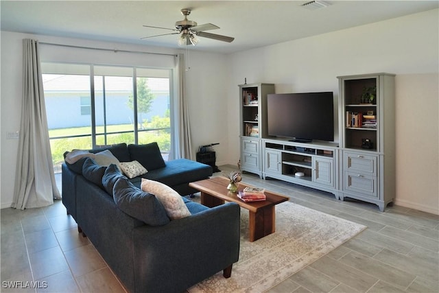 2445 Orchard St, Naples, FL 34120 - living room featuring a ceiling fan and baseboards
