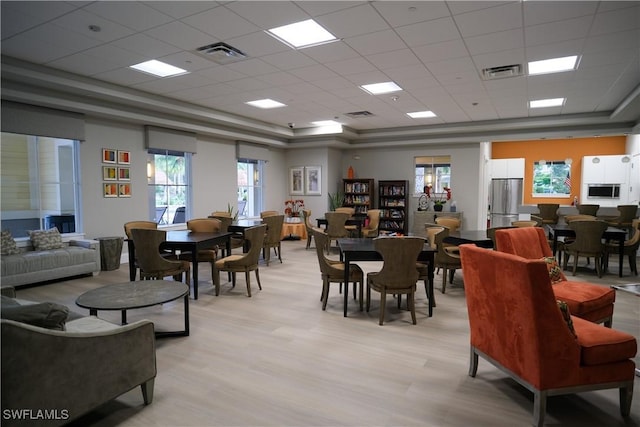 2445 Orchard St, Naples, FL 34120 - dining room featuring a drop ceiling, light wood finished floors, and a raised ceiling