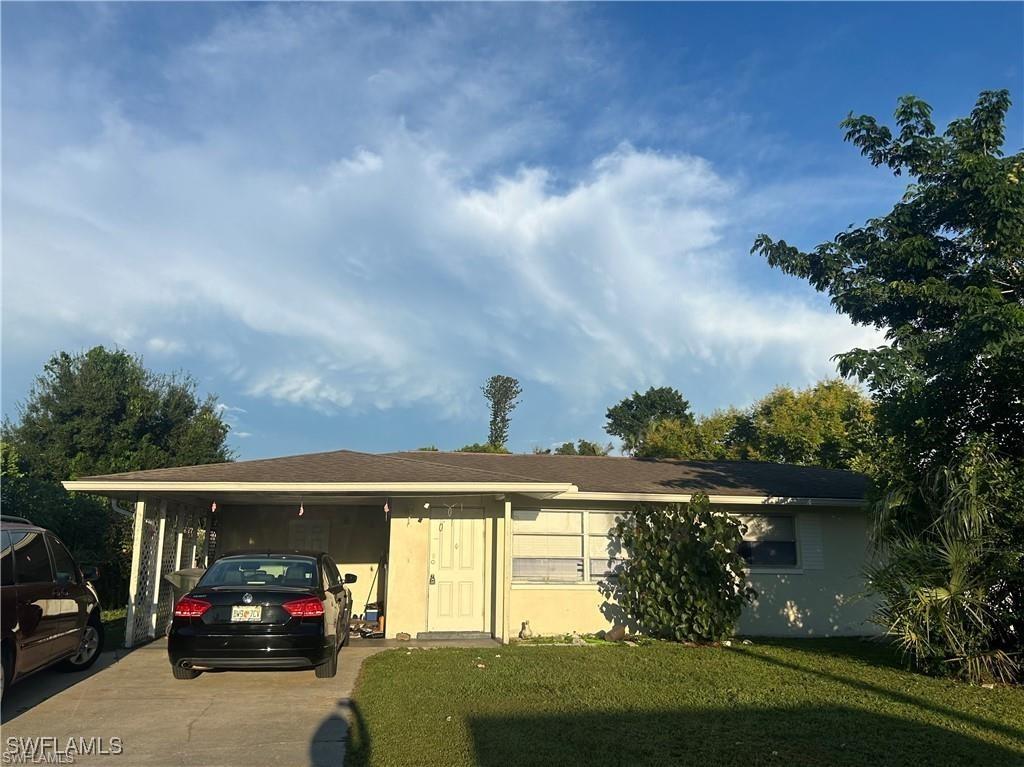 37 Castlebar Cir, Fort Myers, FL 33905 - view of front of house featuring concrete driveway and a front yard