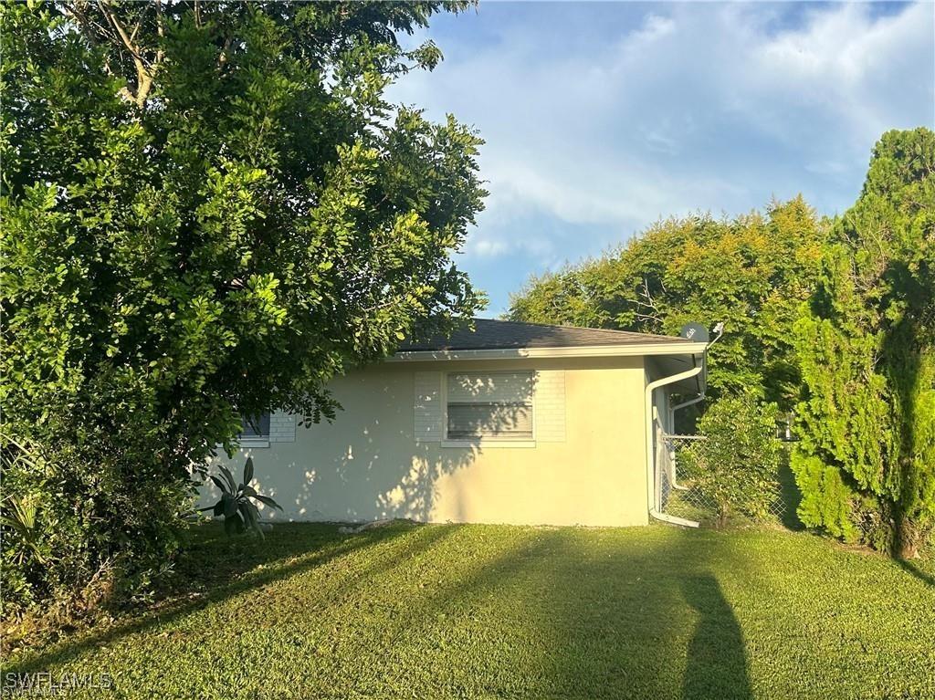 37 Castlebar Cir, Fort Myers, FL 33905 - view of side of property featuring a yard and stucco siding