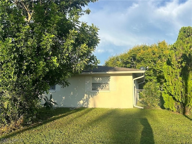37 Castlebar Cir, Fort Myers, FL 33905 - view of side of property featuring a yard and stucco siding