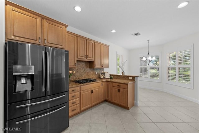 19793 Casa Verde Way, Estero, FL 33967 - kitchen featuring stainless steel refrigerator with ice dispenser, a chandelier, healthy amount of natural light, recessed lighting, and tasteful backsplash