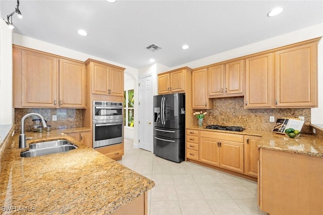 19793 Casa Verde Way, Estero, FL 33967 - kitchen featuring fridge with ice dispenser, stainless steel double oven, gas stovetop, decorative backsplash, and light tile patterned flooring
