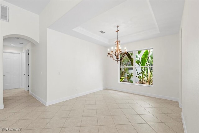 19793 Casa Verde Way, Estero, FL 33967 - unfurnished room featuring arched walkways, a chandelier, a tray ceiling, and light tile patterned floors