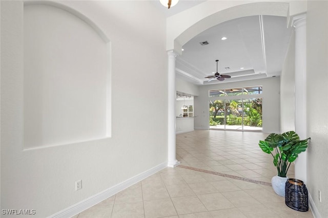 19793 Casa Verde Way, Estero, FL 33967 - hallway with light tile patterned floors, a raised ceiling, decorative columns, recessed lighting, and arched walkways