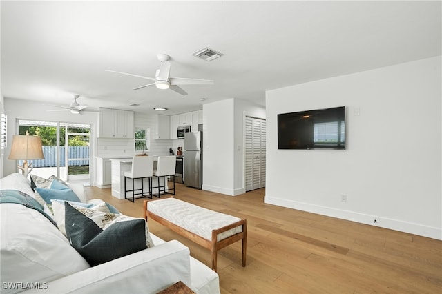 1324 Highlands Dr, Naples, FL 34103 - living room with a ceiling fan and light wood-style floors