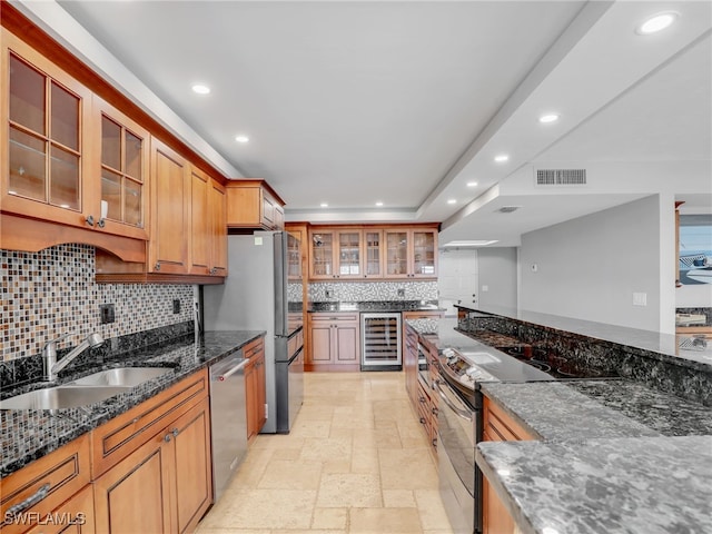 1100 N Collier Blvd Unit 920, Marco Island, FL 34145 - kitchen with beverage cooler, appliances with stainless steel finishes, recessed lighting, backsplash, and dark stone counters