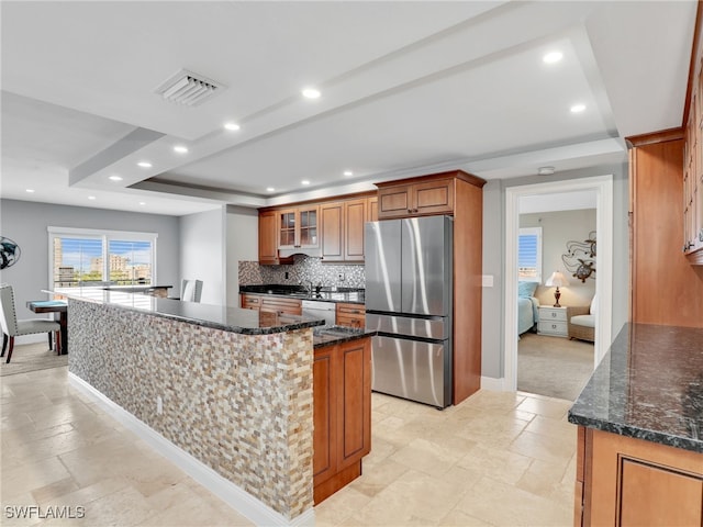 1100 N Collier Blvd Unit 920, Marco Island, FL 34145 - kitchen featuring freestanding refrigerator, dishwasher, a tray ceiling, decorative backsplash, and recessed lighting