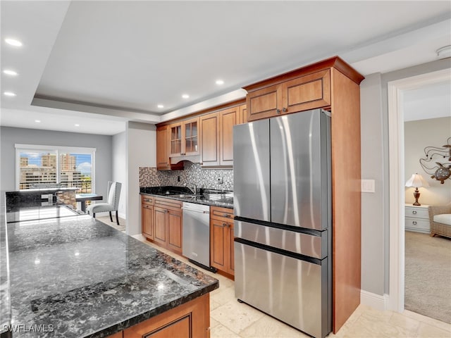 1100 N Collier Blvd Unit 920, Marco Island, FL 34145 - kitchen featuring appliances with stainless steel finishes, brown cabinetry, recessed lighting, backsplash, and glass insert cabinets