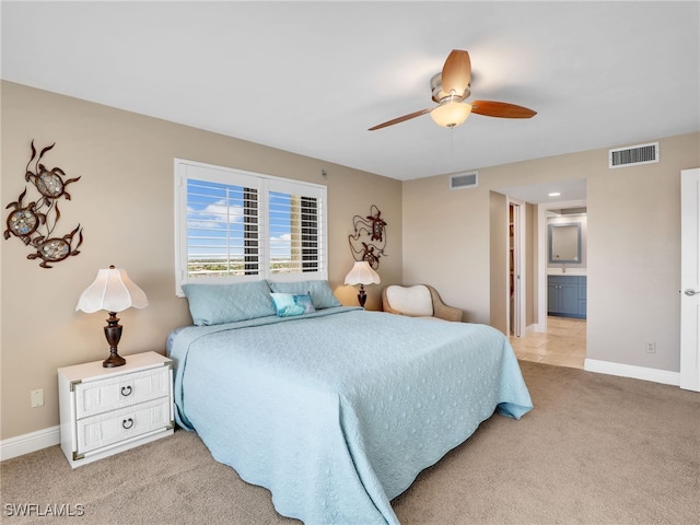 1100 N Collier Blvd Unit 920, Marco Island, FL 34145 - bedroom featuring light carpet, ensuite bathroom, and a ceiling fan