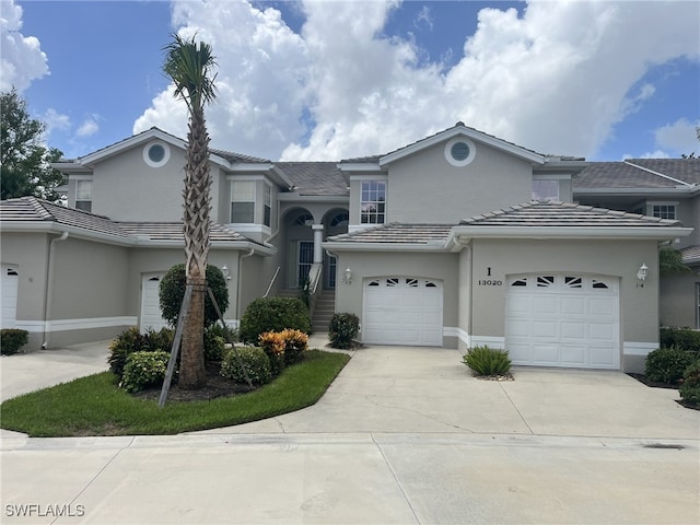 13020 Hamilton Harbour Dr Unit I3, Naples, FL 34110 - view of front of property with stucco siding, concrete driveway, and a tiled roof