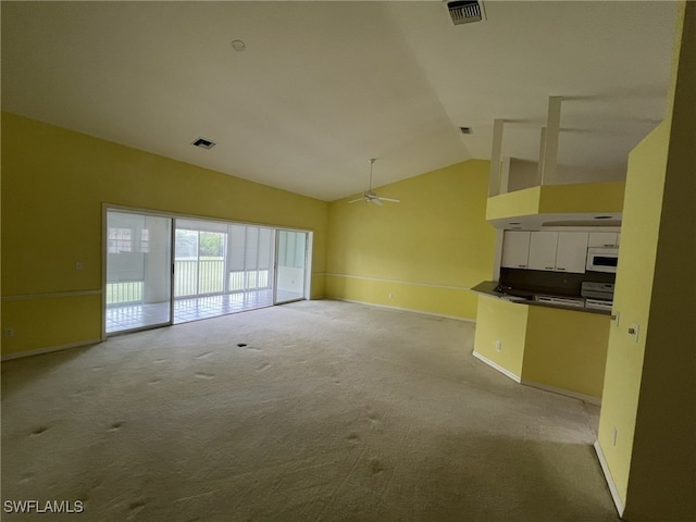 13020 Hamilton Harbour Dr Unit I3, Naples, FL 34110 - unfurnished living room featuring vaulted ceiling, carpet flooring, and ceiling fan