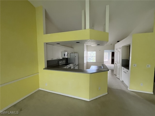 13020 Hamilton Harbour Dr Unit I3, Naples, FL 34110 - kitchen featuring carpet, white appliances, a peninsula, high vaulted ceiling, and white cabinetry
